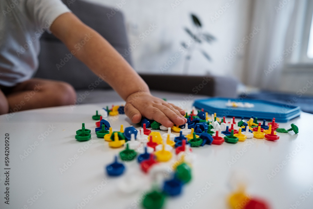 Little child playing peg board mosaic toy at home Little child playing peg board mosaic toy at home