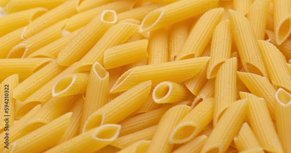 pasta backgroud - macro view of Dry Authentic Italian penne pasta backgroud - macro view of Dry Authentic Italian penne