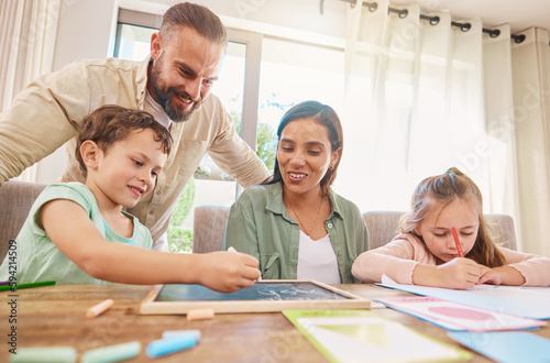 Family, education and homework with a boy writing on a chalkboard while his parents supervise his learning. Kids, school or study with children, a mother and father at home for growth or development