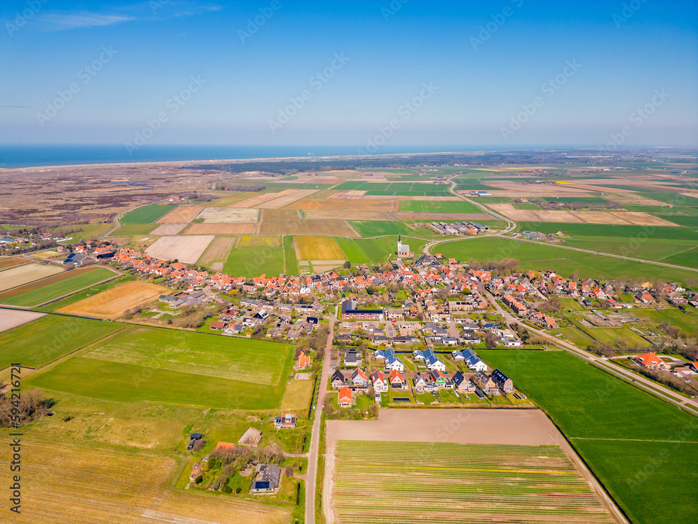 High angle Drone Point of View on the village of Den Hoorn, on the island of Texel, The Netherlands. The Wadden Sea can be seen in the distance.