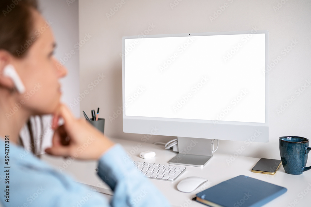 Blank screen of computer and woman looking at screen.