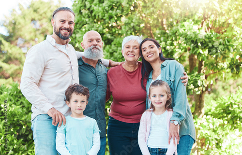 Family is outdoor, smile in portrait with generations, happiness with grandparents, parents and kids in garden. Happy people together, summer holiday and bonding with love, care and support in nature © J Bettencourt/peopleimages.com