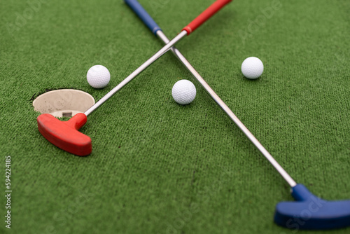 Mini golf close-up, colorful golf putters, balls