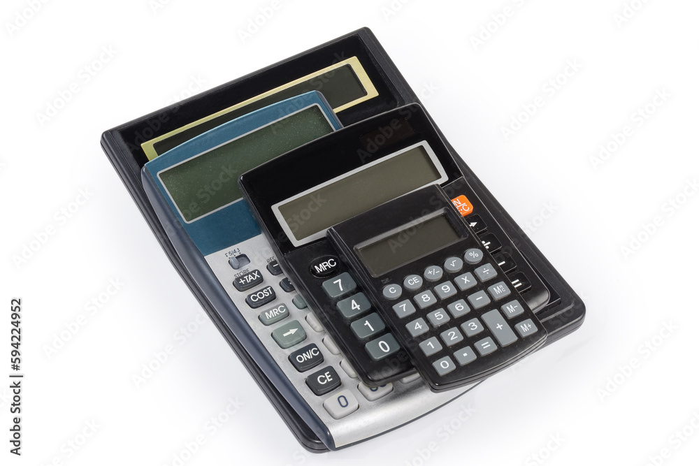 Different used electronic calculators stacked on a white background Different used electronic calculators stacked on a white background