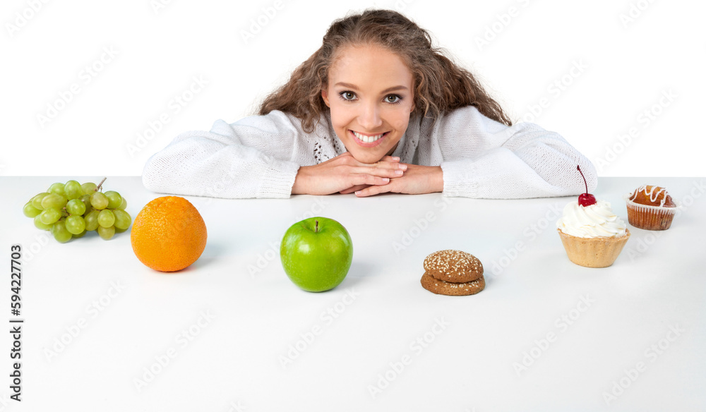 Portrait of a Young Woman Choosing Between Fruits and Cakes