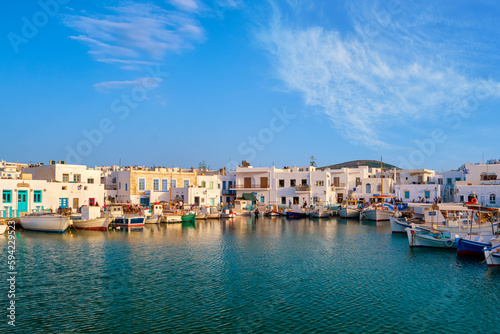 Traditional Greek fishing village and harbour on sunny day, boats