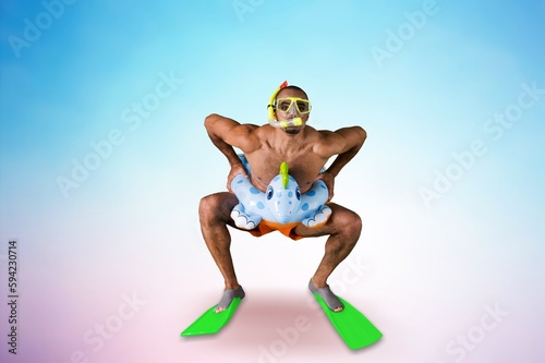 Funny crazy male swimmer in swimming circle posing © BillionPhotos.com