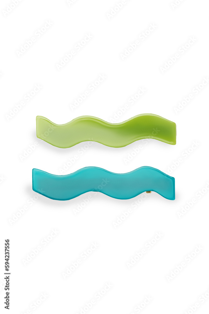 Detailed shot of two elegant blue and green hair clip made as a wave. Bright hairpins are isolated on the white background. Vogue accessory for ladies and girls. Front view.