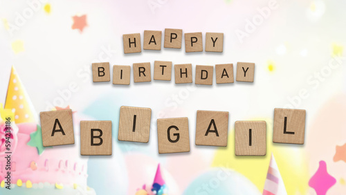 Happy Birthday Abigail card with wooden tiles text. Girls birthday card with colorful background. photo