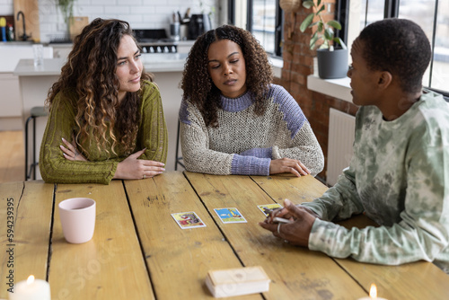 Females Friends Reading Tarot cards on Kitchen table