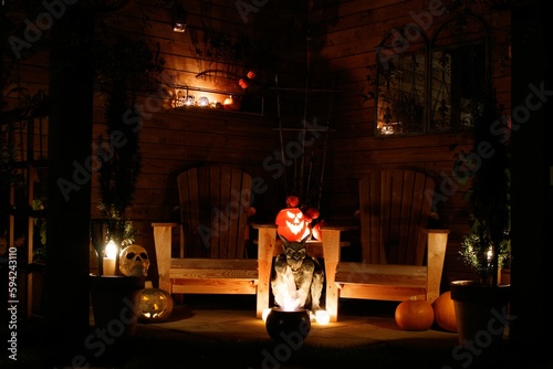 Outdoor Halloween-themed setting with wooden benches and pumpkins