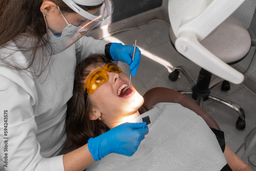 Dentist checks for violations in the natural bite after treatment with