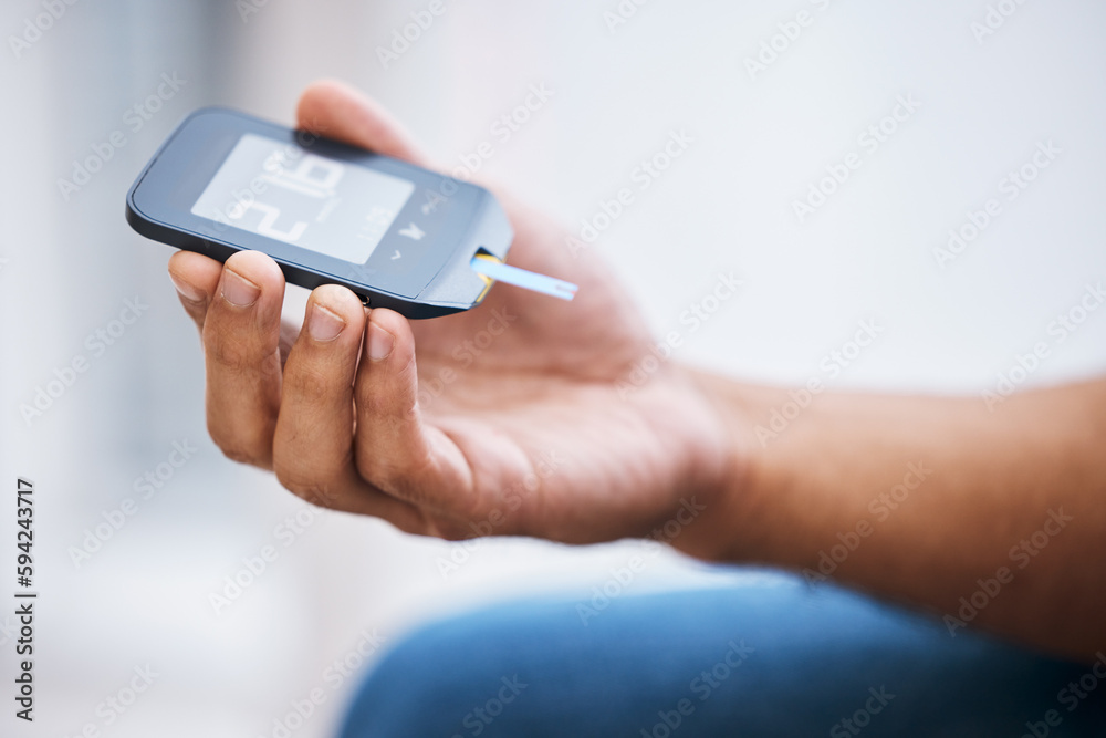 Hand, diabetes and measurement with a man in his home holding a blood glucose meter for disability awareness. Healthcare, medical and sugar with a diabetic male testing insulin levels in his house Hand, diabetes and measurement with a man in his home holding a blood glucose meter for disability awareness. Healthcare, medical and sugar with a diabetic male testing insulin levels in his house