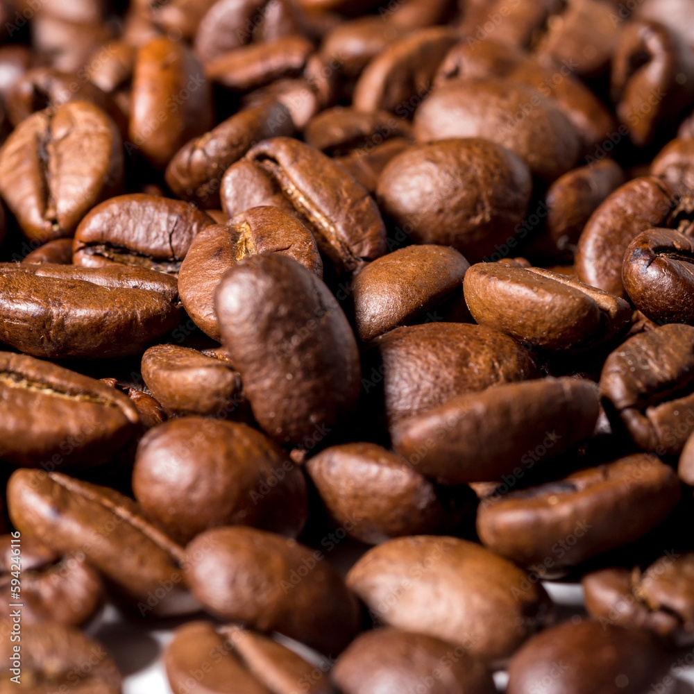 Heap of fresh roasted coffee beans isolated on white background as package design elements Heap of fresh roasted coffee beans isolated on white background as package design elements