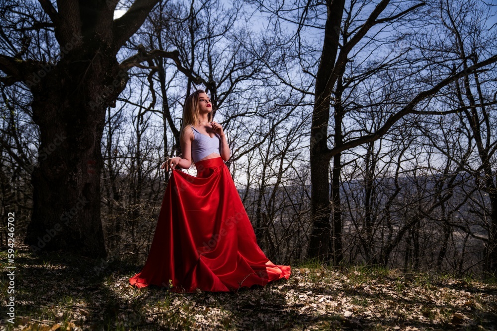 Caucasian woman with blonde hair posing in forest