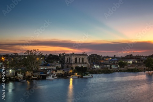 San Juan passing through the city of Matanzas in Cuba with the golden sunset in the background © Raul Navarro González/Wirestock Creators