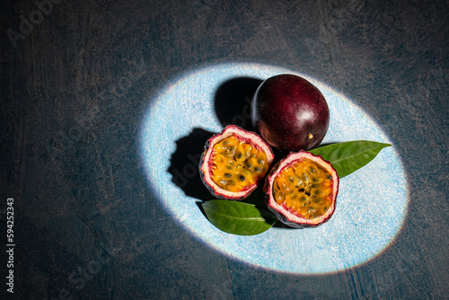 Passion fruits on dark background. Set of whole and half of fresh passion fruit. place for text, top view