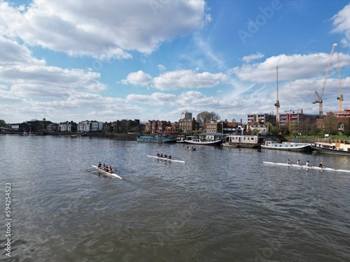 Tableau sur toile Three rowing boats  on River Thames at Puntney London UK drone aerial view