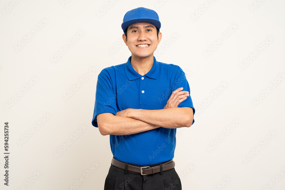 Happy delivery asian man in blue uniform standing on isolated white background. Smiling male service worker. Delivery courier and shipping service. Happy delivery asian man in blue uniform standing on isolated white background. Smiling male service worker. Delivery courier and shipping service.