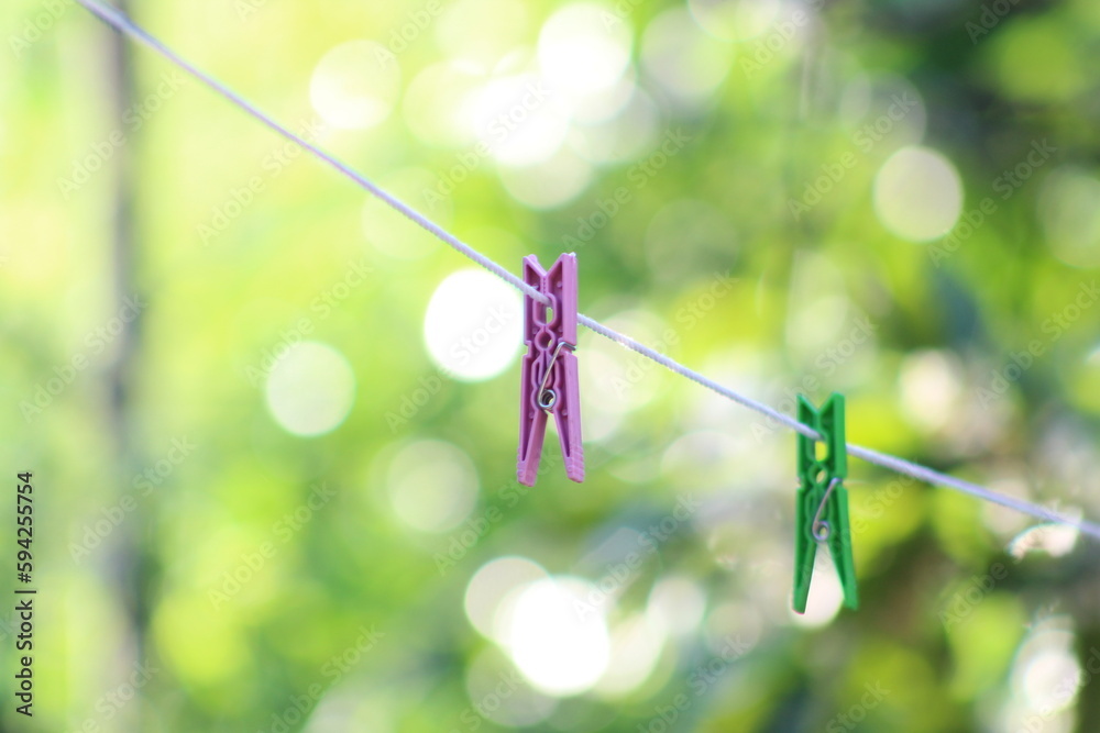 Pink clothes peg on white clothesline. Selective focus. Pink clothes peg on white clothesline. Selective focus.
