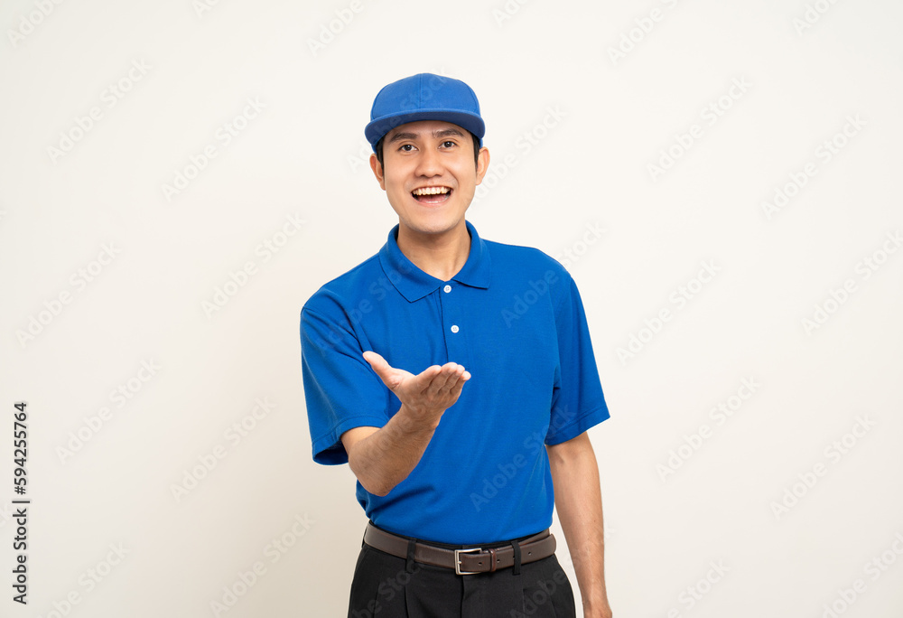 Happy delivery asian man in blue uniform standing on isolated white background. Smiling male service worker. Delivery courier and shipping service. Happy delivery asian man in blue uniform standing on isolated white background. Smiling male service worker. Delivery courier and shipping service.