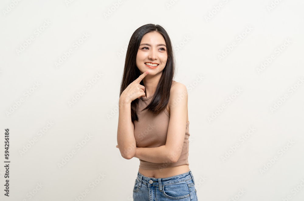 Beautiful smiling happy young asian woman in brown shirt. Charming female lady standing pose thinking on isolated white blank background. Asian cute people looking copy space for text advertise Beautiful smiling happy young asian woman in brown shirt. Charming female lady standing pose thinking on isolated white blank background. Asian cute people looking copy space for text advertise