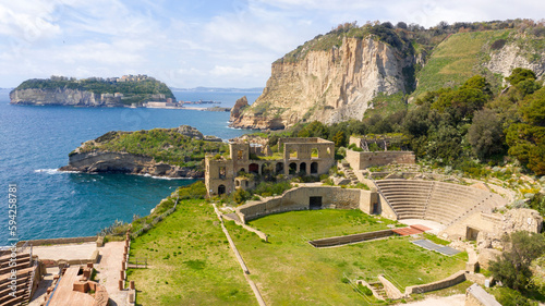 Aerial view of the Roman theater in the Pausilypon archaeological park. These ancient Roman ruins are located in Posillipo district in Naples, Campania, Italy. In the background the island of Nisida. photo