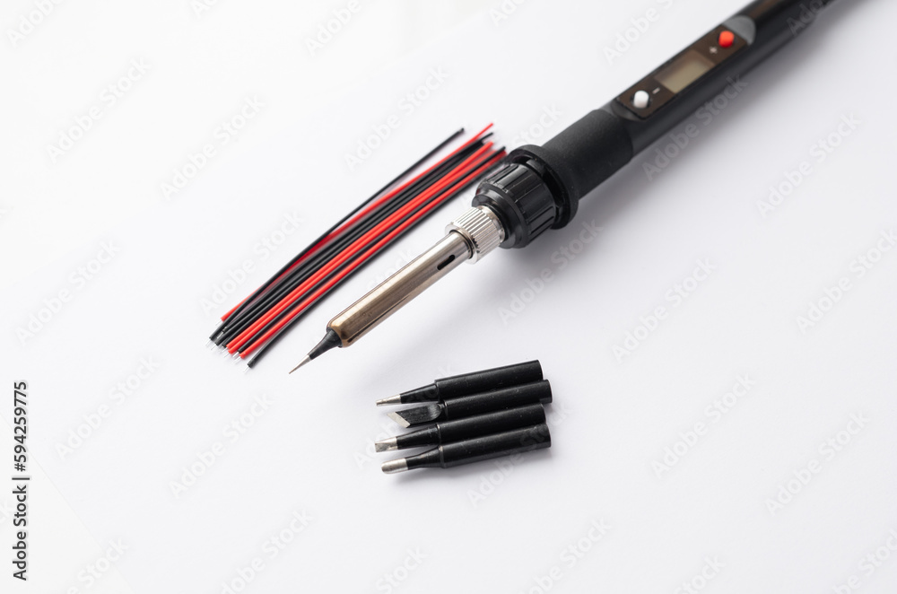Close up of soldering tips on glass table, silver background with equipment for soldering iron Close up of soldering tips on glass table, silver background with equipment for soldering iron