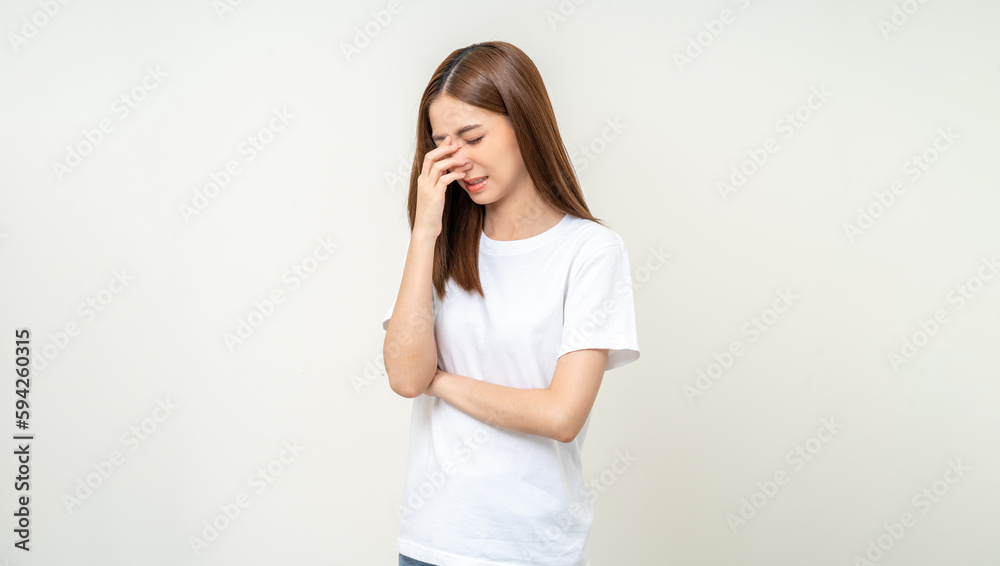 Young asian beautiful woman hand rubbing eyes she's feeling depressed stress headache be tired from working standing on isolated white background she has health problems. Young asian beautiful woman hand rubbing eyes she's feeling depressed stress headache be tired from working standing on isolated white background she has health problems.