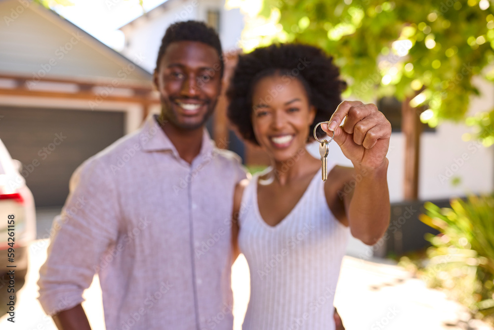 Fototapeta premium Portrait Of Couple Outdoors Holding Keys To Dream Home