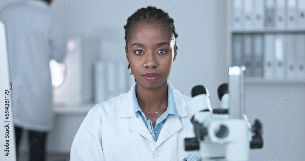 Black woman, scientist with serious face and science study in laboratory, microscope and medical research. Portrait, happy female doctor with experiment and scientific innovation in biotechnology