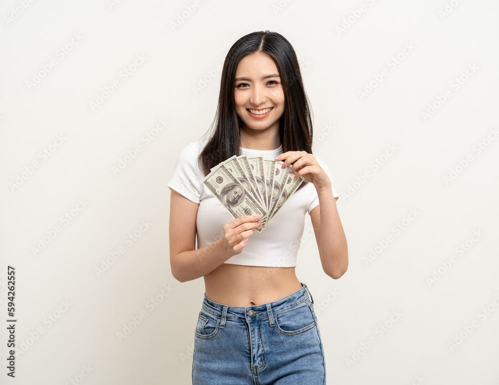 Cheerful young Asian business woman showing lot of money. Attractive female with dollar banknotes. Happy asian woman counting money us dollar Financial business concept on isolated white background Cheerful young Asian business woman showing lot of money. Attractive female with dollar banknotes. Happy asian woman counting money us dollar Financial business concept on isolated white background
