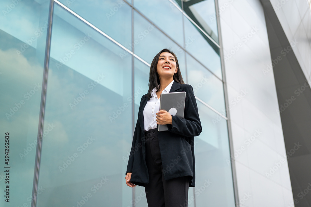 Portrait beautiful Businesswoman in suit with tablet standing at the buildings downtown. Confident woman using tablet. Executive Smart businessman Portrait beautiful Businesswoman in suit with tablet standing at the buildings downtown. Confident woman using tablet. Executive Smart businessman