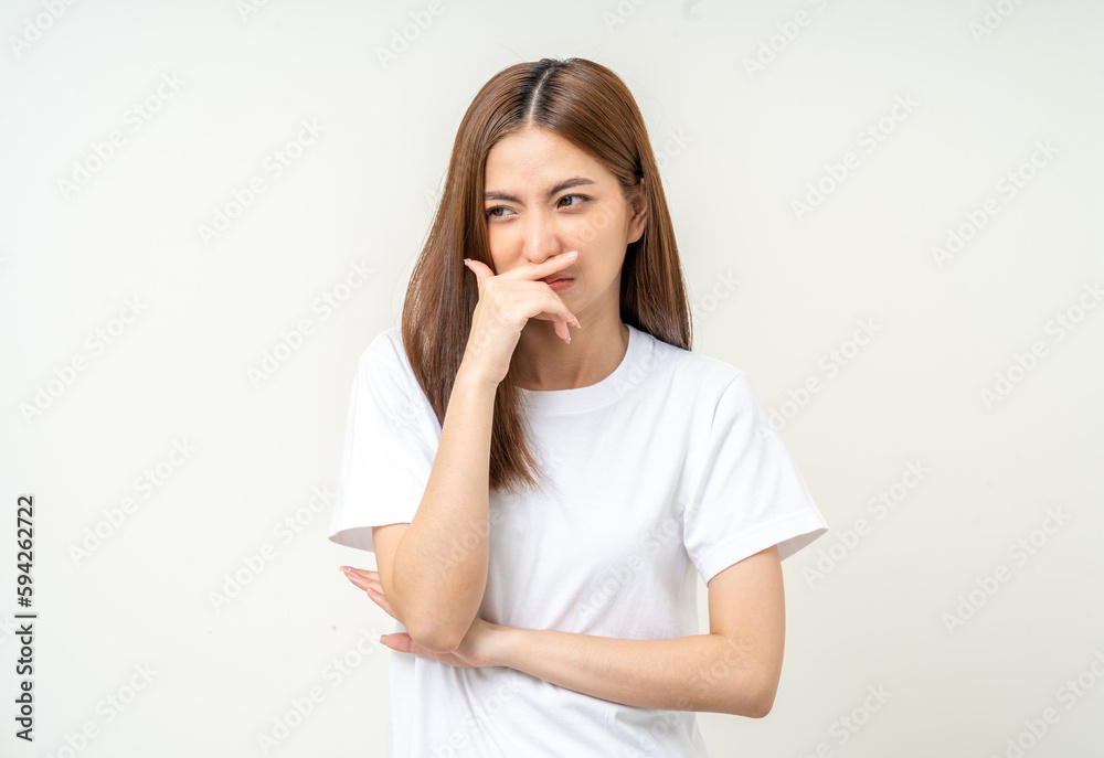 Bad smell stinks. Young beautiful asian woman pinching nose with disgust. Holding breath with fingers on nose Bad smell stinks. Young beautiful asian woman pinching nose with disgust. Holding breath with fingers on nose