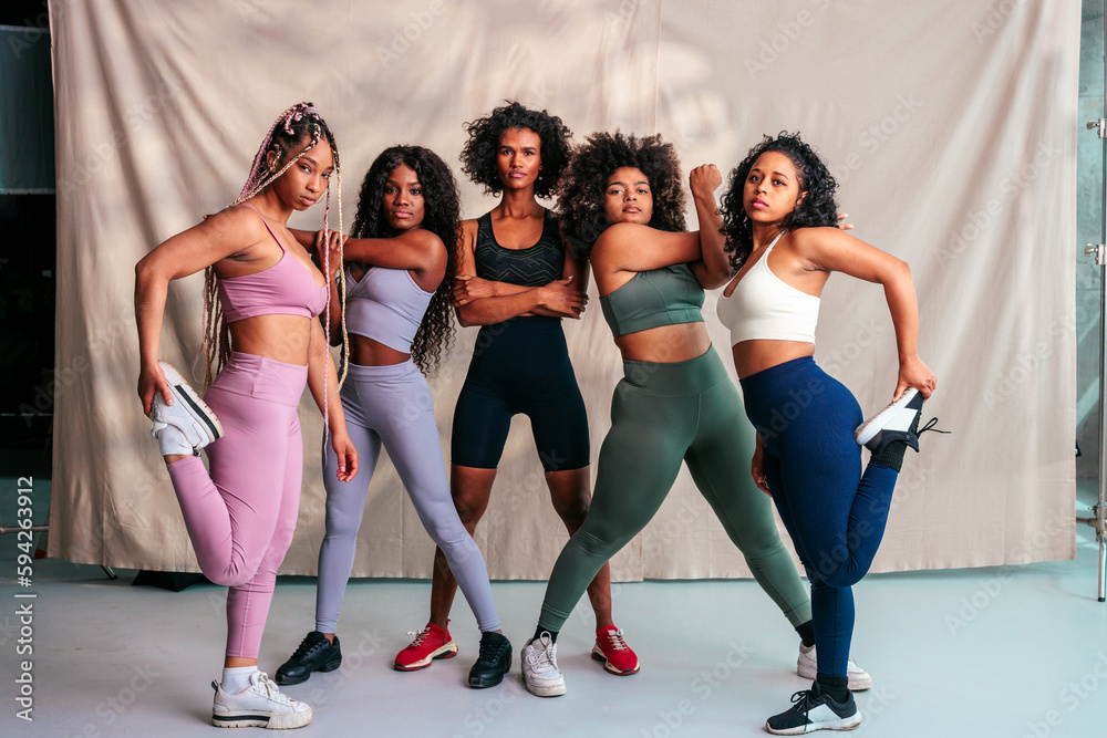 Fototapeta premium Athletic women stretching indoors.