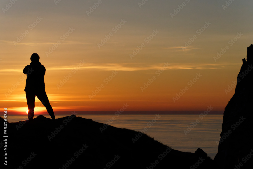 silhouette of a person at the sea