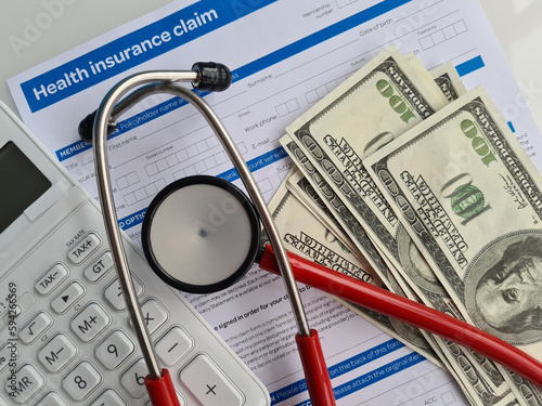 Stethoscope and calculator placed on health insurance documents