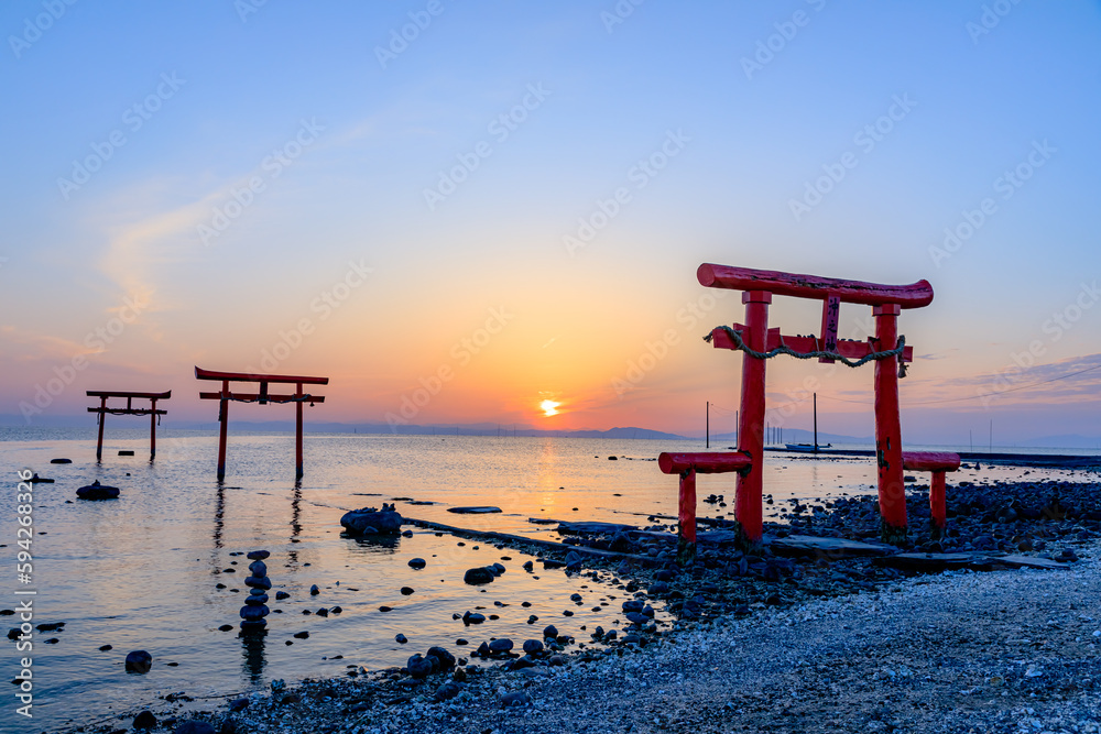 満潮時の大魚神社の海中鳥居と日の出 佐賀県太良町 Undersea torii gate and sunrise at Oouo Shrine at high tide. Saga prefecture Tara town. 満潮時の大魚神社の海中鳥居と日の出 佐賀県太良町 Undersea torii gate and sunrise at Oouo Shrine at high tide. Saga prefecture Tara town.