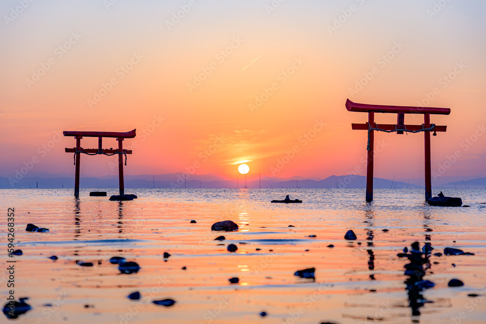 満潮時の大魚神社の海中鳥居と日の出 佐賀県太良町 Undersea torii gate and sunrise at Oouo Shrine at high tide. Saga prefecture Tara town. 満潮時の大魚神社の海中鳥居と日の出 佐賀県太良町 Undersea torii gate and sunrise at Oouo Shrine at high tide. Saga prefecture Tara town.