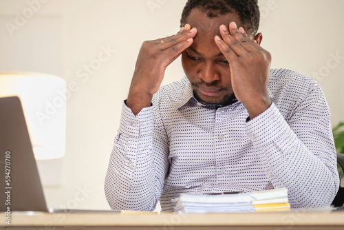 An American businessman with black skin in Africa feels uncomfortable at work and wrist pain is caused by the accumulated stress from failing to complete the job. and the body rests a little.