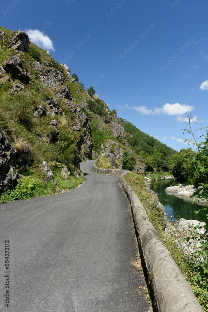 narrow mountain road on blue sky background