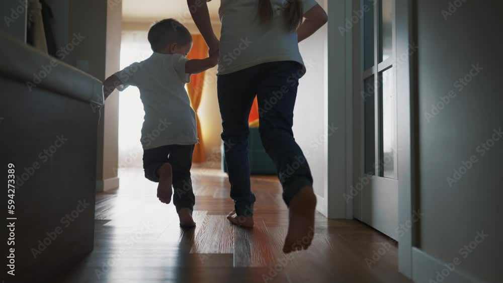 children running around the house playing silhouette. happy family kid dream concept. kids feet running back view indoors light from dream window. children run and play. brother sister run lifestyle