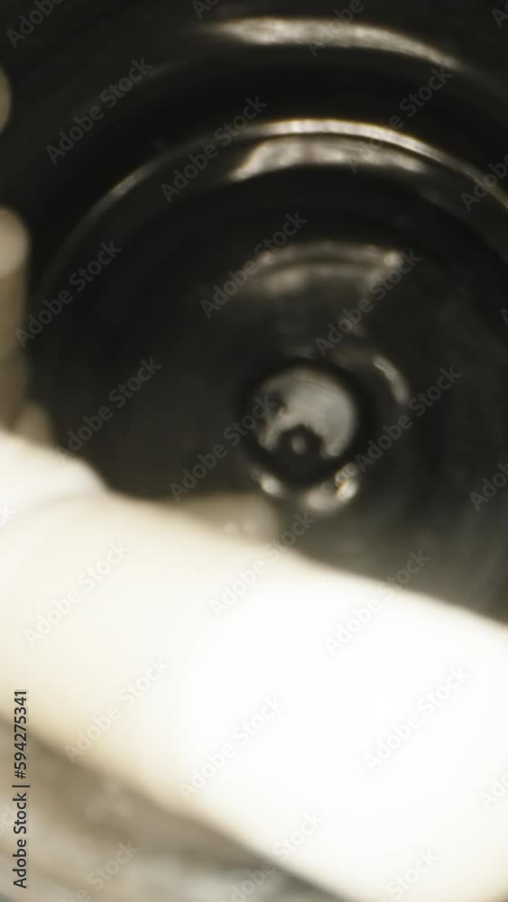 Tablets in the form of white capsules are spinning in a black jar. Camera inside. Dolly slider extreme close-up. Vertical video Social Media Tablets in the form of white capsules are spinning in a black jar. Camera inside. Dolly slider extreme close-up. Vertical video Social Media