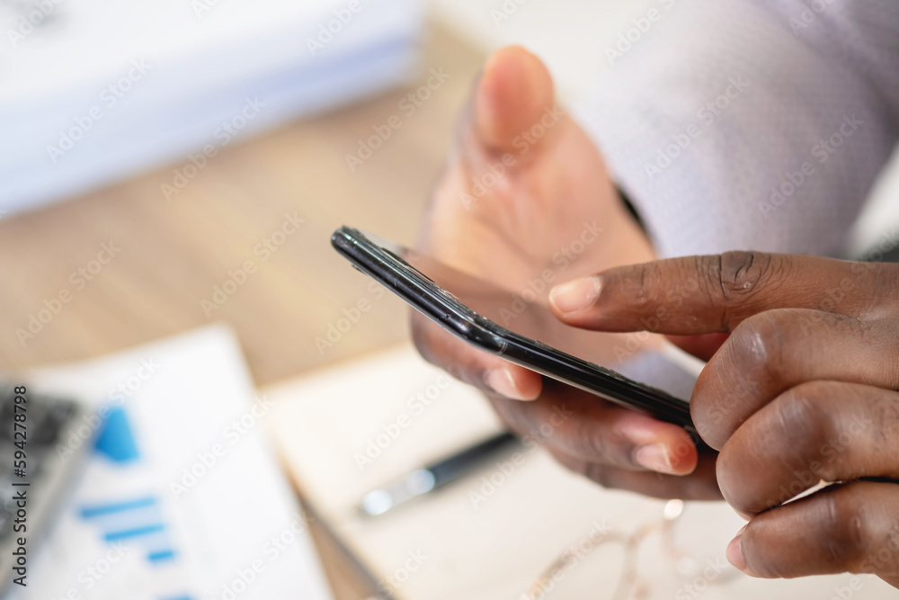 African black businessmen sit on mobile phones communicating with clients and making financial reports and studying annual profit analysis. An accountant checks the financial status of the company. African black businessmen sit on mobile phones communicating with clients and making financial reports and studying annual profit analysis. An accountant checks the financial status of the company.