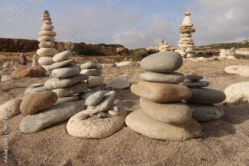 Stone towers stacked with stones on a Cypriot beach photo