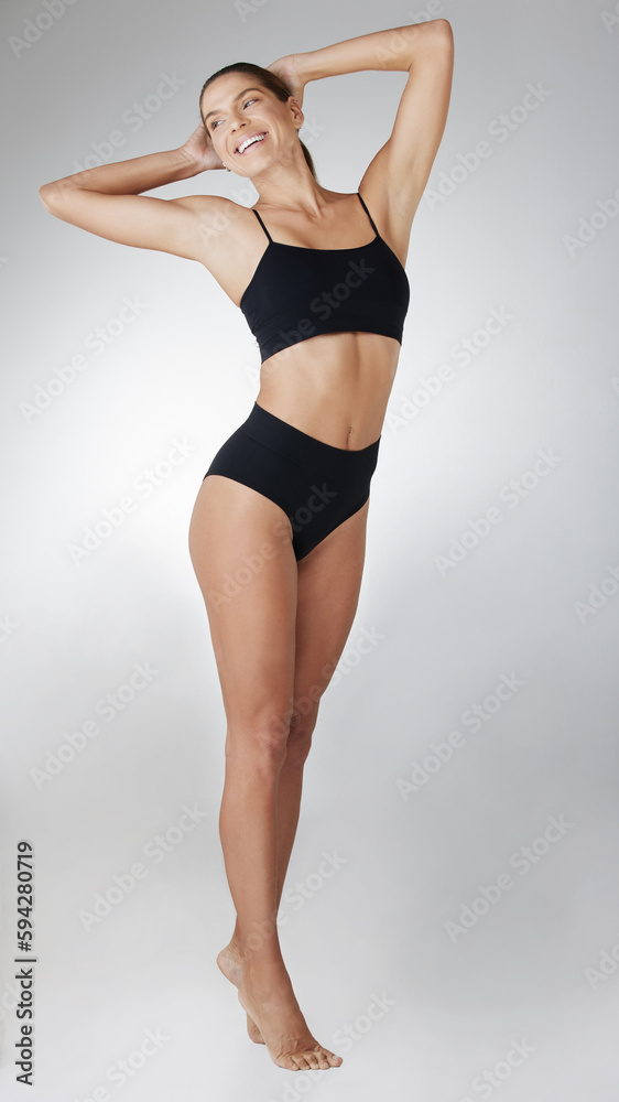 The goddess of body goals. Studio shot of an attractive young woman posing in her underwear against a grey background. The goddess of body goals. Studio shot of an attractive young woman posing in her underwear against a grey background.