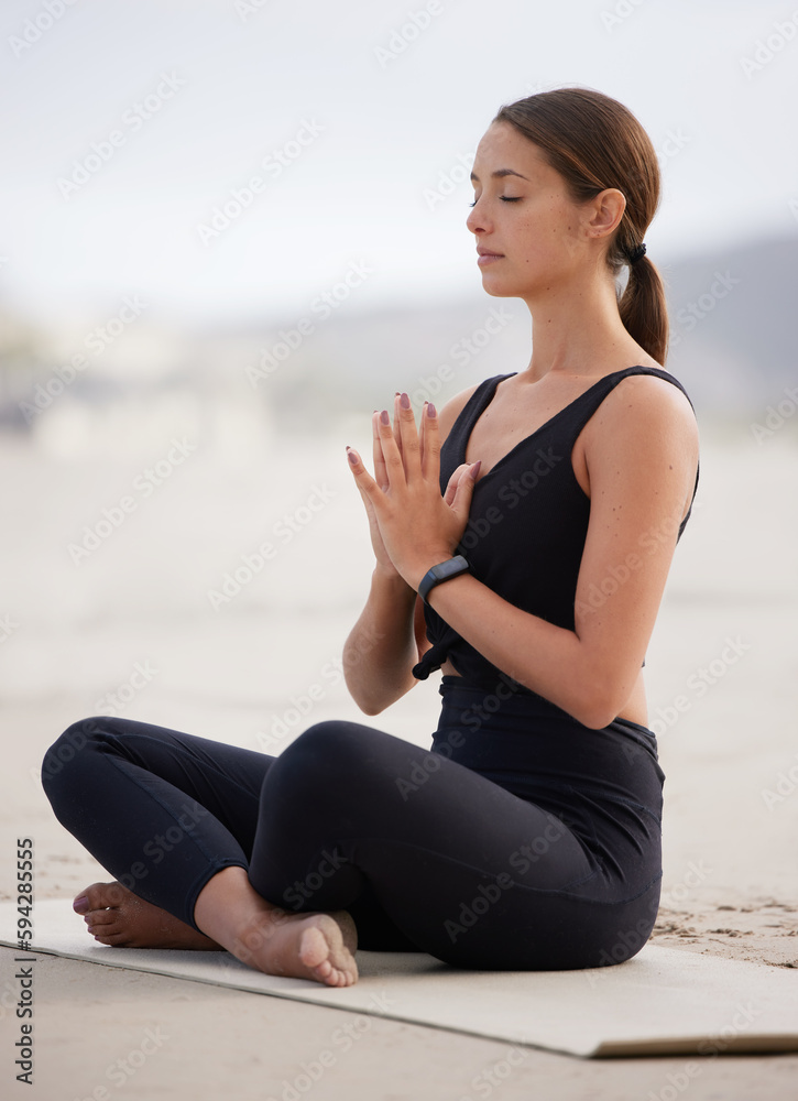 Take this moment to focus on yourself. a young woman meditating while practising yoga at the beach.