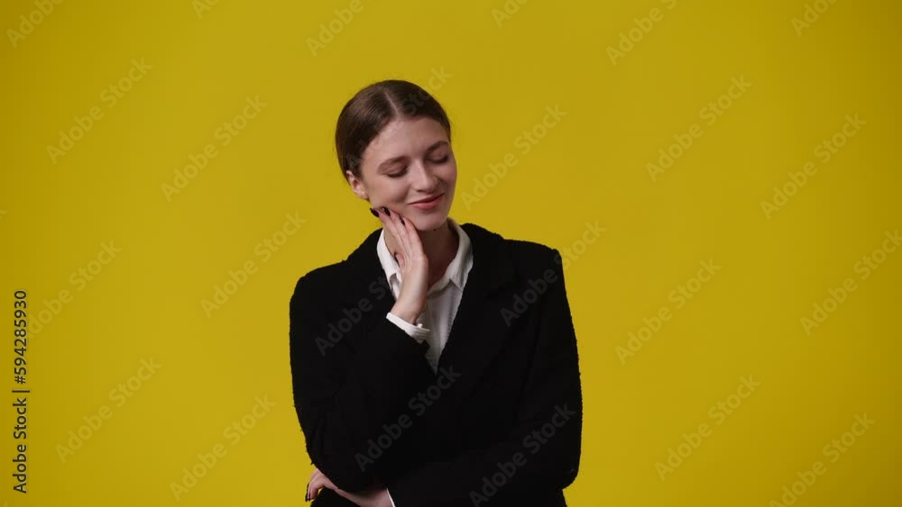 4k video of girl with thoughtful facial expression on yellow background. 4k video of girl with thoughtful facial expression on yellow background.