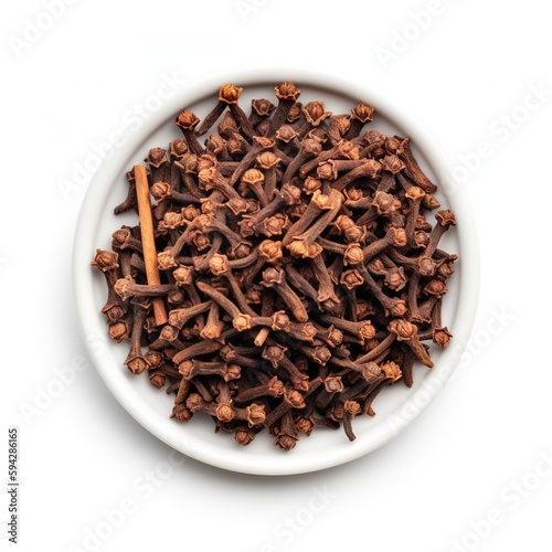 Dried cloves on white bowl, isolated on white background. Top view. Ingredient, recipe, dessert, drink.