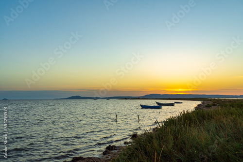 sunset over the sea with boats in South Sardinia